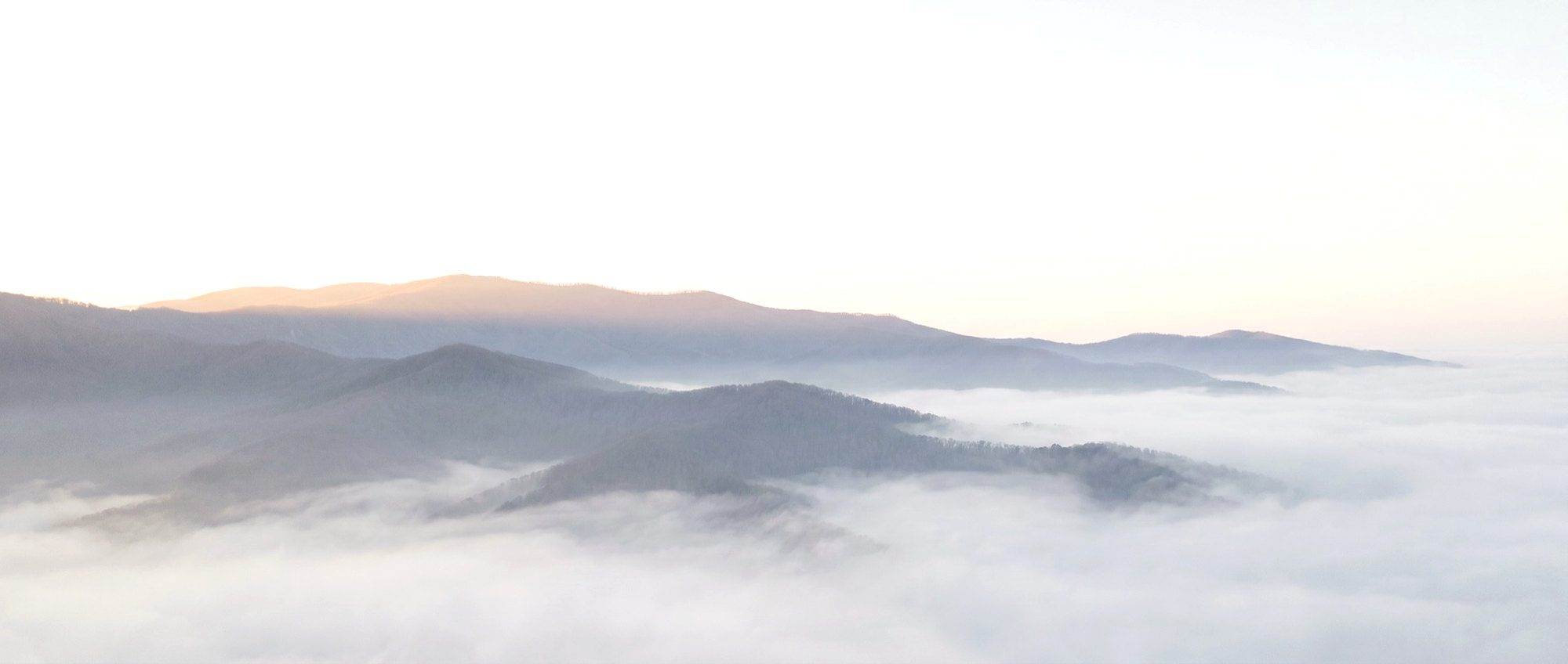 Misty mountain ridgelines at dawn